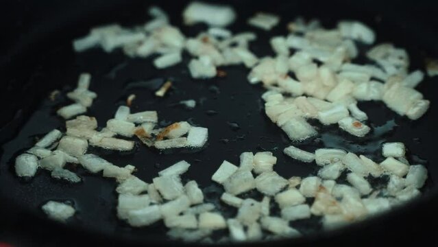 A crispy close up shot, some raw ognions on the grill, omlet preparation, making a breakfast 4K video