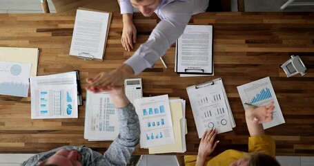 Group of business people rejoicing and giving five together at table at seminar top view 4k movie slow motion. Business seminars and briefings successful business concept