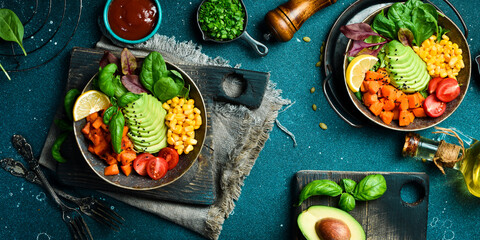 Healthy vegetable lunch with avocado, pumpkin, corn and lettuce. Vegetarian salad. Healthy balanced eating. Buddha bowl. - obrazy, fototapety, plakaty