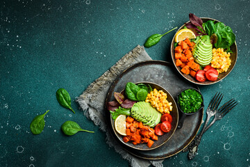 Healthy vegetable lunch with avocado, pumpkin, corn and lettuce. Vegetarian salad. Healthy balanced...