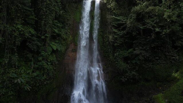 The beautiful Gitgit waterfall surrounded by Balinese jungle, aerial.