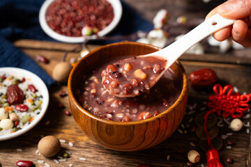  red rice porridge in a bowl. traditional food Laba porridge on table.