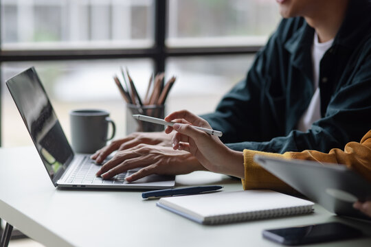 Technology and financial advisory services concept. Business teamwork and working on digital laptop computer with advisor showing plan of investment to clients at table office. Digital marketing.