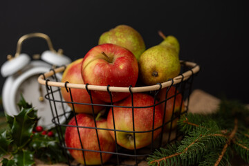 apples in a basket,Apples and pears in a metal basket, juicy fruits on the background, fresh and tasty