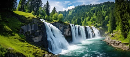  Reinfall waterfall in Switzerland: Europe's largest, powerful and beautiful, surrounded by lush green landscapes. © 2rogan