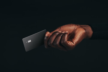 Going cashless with premium benefits, man uses his black credit card to make a payment