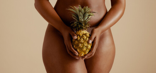 Body positivity: Sensual woman embracing wellness with pineapple