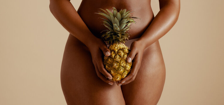 Body positivity: Sensual woman embracing wellness with pineapple