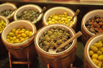 Artisanal olives displayed, inviting market shoppers. Symbolizes the farm-to-table movement's focus on quality.