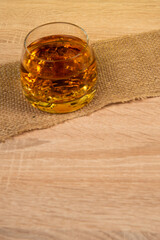 glass of whiskey with ice on a wooden background, exclusive alcoholic drink