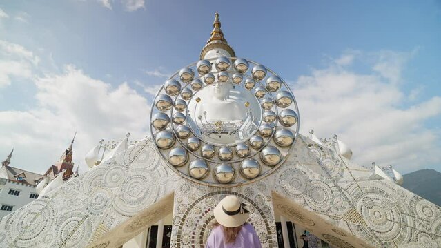 Woman tourist walking and admiring the beauty statue of buddha and buddhist monastery at Wat Pha Sorn Kaew or Phra Thart Pha Kaew in Khao Kor, Phetchabun, Thailand. Landmark of khao kor