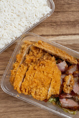 top view fast food with chicken cutlets and bbq porks and rice at vertical composition