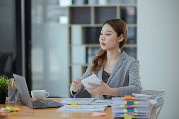 Asian Accounting Woman Working at Desk In Office. Business Financial and Accounting concept.