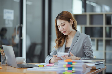 Asian Accounting Woman Working at Desk In Office. Business Financial and Accounting concept.