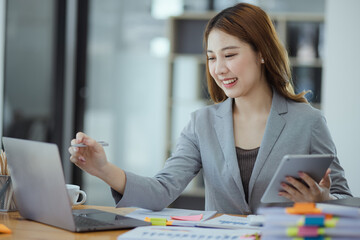 Asian Accounting Woman Working at Desk In Office. Business Financial and Accounting concept.