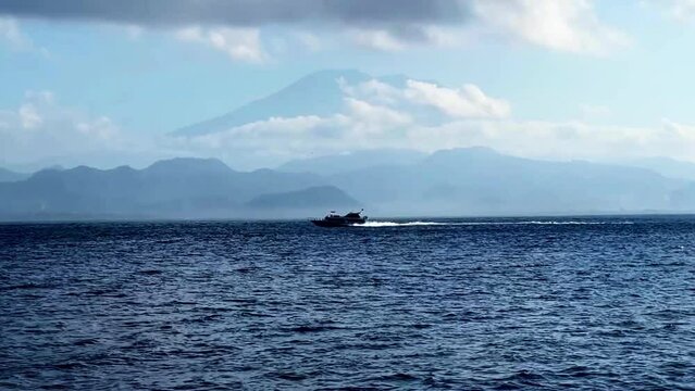 cinematic short A boat is going through the water, waves are happening in the water from behind the boa