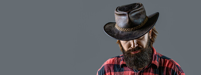 Cowboy Hat. Portrait of young man wearing cowboy hat. Cowboys in hat. Handsome bearded macho. Man...