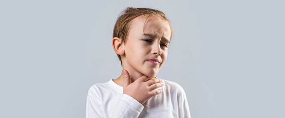 Ill little boy with sore throat. Ill child with sore throat. Sore throats in a child. Child has a sore throats. Signs of a cold in children. Young boy feels that his throat is pain - obrazy, fototapety, plakaty
