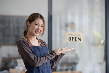 Happy smelling Asian woman owner with open sign broad and ready to service, Small startup business...
