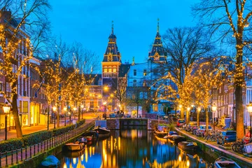 Poster Amsterdam Netherlands canals with Christmas lights during December, canal historical center of Amsterdam at night in December during the Christmas holidays in the Netherlands © Fokke Baarssen