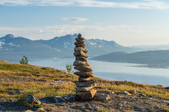 Stack of stones on top of a cliff - Powered by Adobe
