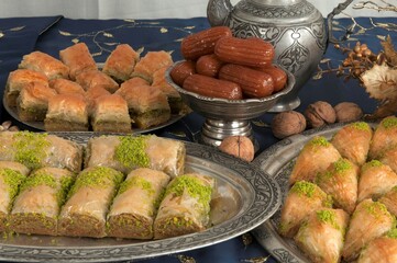 A traditional Turkish dessert made with dough, pistachios and walnuts. Baklava and various Turkish desserts on a table.