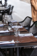 Table setting in a restaurant for serving dinner, empty wine glasses on the table in the restaurant