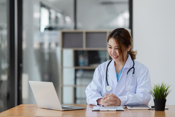 Asian female doctor with patient clipboard at hospital, Medicine and healthcare concept.