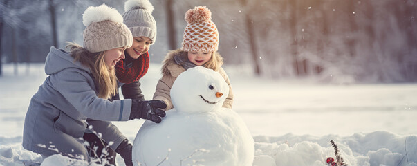 Happy girl in winter time build snowman from fresh snow.  Christmass concept.  banner