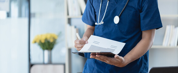 Doctor working with patient clipboard in hospital, Health care and medical concept.