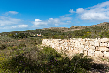 Fototapeta premium still bay river valley a Mediterranean landscape of rolling hills and dry stone walls