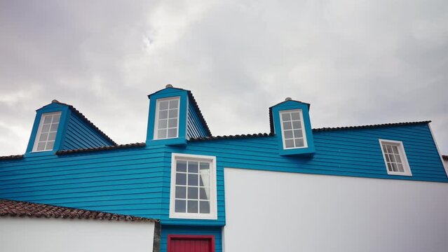 Close up shot of the exterior of modern wooden house. White and blue turquoise painted. Residential house.