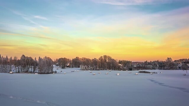 Time lapse flowing clouds over in winter, Snow-covered tree foreground