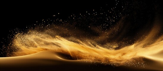 Explosion of fine sand golden grains abstract clouds yellow silica in air galaxy symbol Black background isolated Copy space image Place for adding text or design