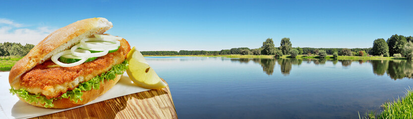 Lake in Summer with Baked Fish in a Bun - Panorama - 686071317