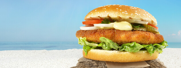 Fish Burger at the Sea - Coast Panorama with Baked Fish in a Bun - 686071512