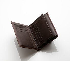 Close-up shot of a fashionable leather men's wallet on a white background with reflection