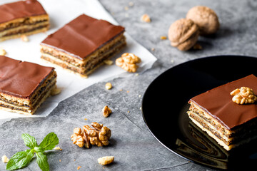 Gerbeaud Cake. Zserbo. Traditional Hungarian multi-layer cake with plum jam, nuts and covered with chocolate glaze