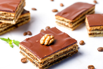 Gerbeaud Cake. Zserbo. Traditional Hungarian multi-layer cake with plum jam, nuts and covered with chocolate glaze