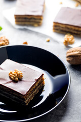 Gerbeaud Cake. Zserbo. Traditional Hungarian multi-layer cake with plum jam, nuts and covered with chocolate glaze