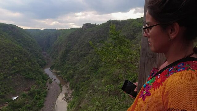 Latina woman enjoys viewpoint over Somoto Canyon in Nicaragua jungle