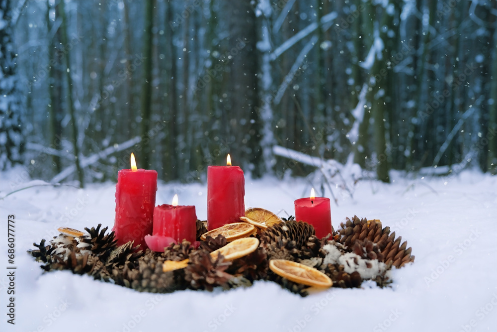 Wall mural winter nature background with burning candles. candles, cones, dry orange slices in snow. magic winter scene in forest. Christmas, New Year Holidays. witchcraft ritual for Yule, Winter Solstice