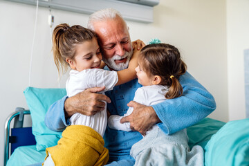 Little girls visiting grandfather in hospital, who is recovering from coronavirus.