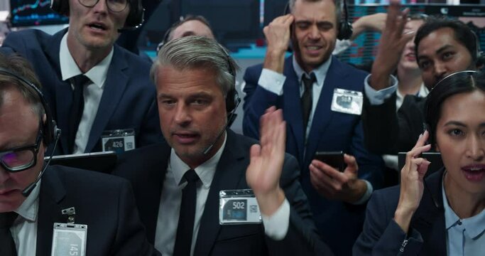 Portrait of Professional Traders Working on a Stock Exchange. Enthusiastic Men and Women Shouting, Signaling Orders for Company Shares and Commodities to Brokers at an Open Outcry Arbitrage