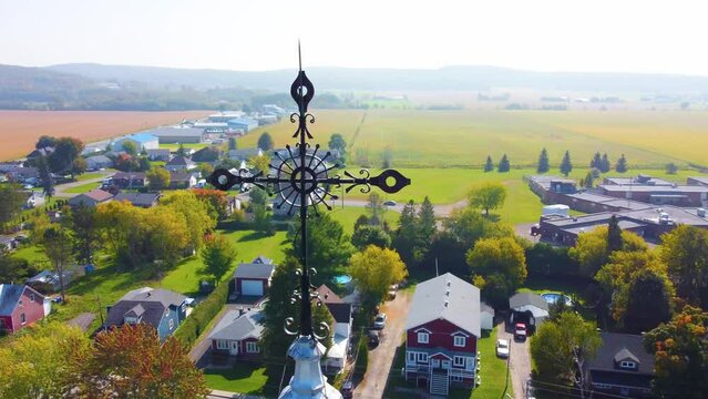 Orbital drone shot of a neighborhood and nearby farmlands located in Montr&eacute;al, in Qu&eacute;bec, Canada during fall season.

