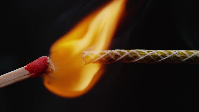 Sparks Shower as Match Ignites Fuse on Black Background