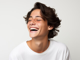 Beautiful teenage boy laughing. Full mouth smile. Isolated on white background