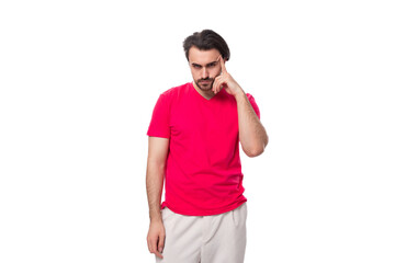 Fototapeta premium young pleasant slender brunette man with a cool hairstyle is dressed in a red t-shirt