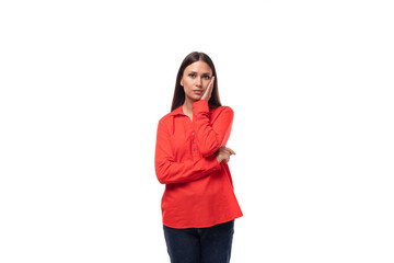 upset young business woman with black hair dressed in a red blouse on a white background with copy space