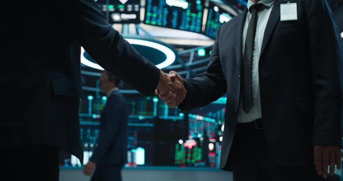 Two Corporate Business Partners Agree on Successful Deal, Shake Hand in Office. Banker and International Company Representative Collaborate on Lucrative Investment Opportunity. Anonymous Businessmen